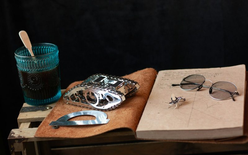 silver and black ring on brown wooden board
